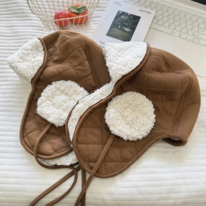 Brown quilted winter bomber hat with warm faux shearling lining for cold weather
