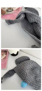 Detailed knit texture of a grey koala beanies with animal ears and handcrafted crochet finish