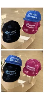 Close-up of hip-hop flat brim caps with runners embroidery and graffiti polka dots