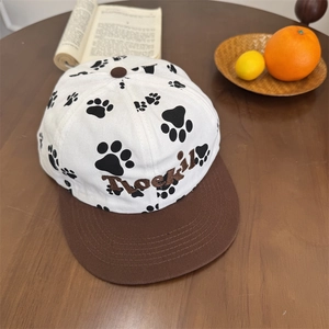 Cute puppy paw print baseball cap with contrast brim and letter embroidery on wood table