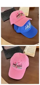 Close-up of floral embroidery and Sunset Flower text on vintage cotton baseball caps