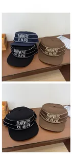 Detail of vintage cotton cadet caps with embroidery in black, navy, and brown colors