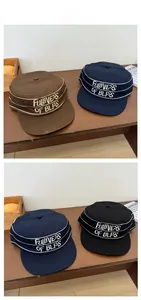Detail of striped patrol cap showing embroidered Fullness of Bliss text and eyelets