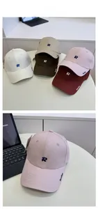 Detail of embroidered R logo and Realize text on premium cotton baseball caps