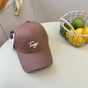Brown hard top baseball cap with white Today embroidery shown in a lifestyle scene