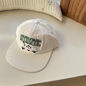 White cotton baseball cap with green Authentic embroidery and dog patch detail