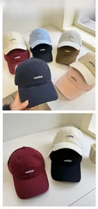 Detail of embroidered cotton baseball caps in multiple colors showing the nabita logo