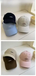 Detail of embroidered cotton baseball caps in six colors with a minimalist nabita logo