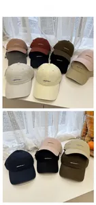 Detailed tile display of various cotton baseball caps with elegant script embroidery