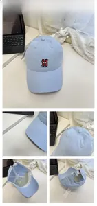 Detailed views of light blue baseball cap with red H embroidery and cartoon cat detail