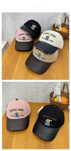 Detail view of cotton baseball caps with bear embroidery and contrast leather brims