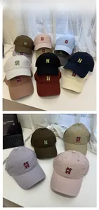 Collection of soft cotton baseball caps with H embroidery and cartoon detail