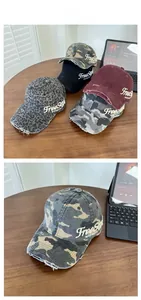 Detail of vintage washed denim baseball caps featuring distressed brims and embroidery