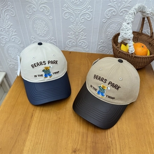Two-tone cotton baseball cap featuring cartoon bear embroidery and wide brim for sun protection
