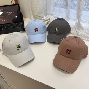 Minimalist soft-top baseball caps with 'H' embroidery in various colors on white table