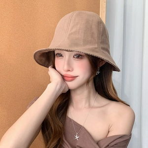Women's reversible plaid bucket hat in tan linen with sun protection for outdoor wear