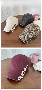 Detail of distressed baseball caps in multiple colors with side super 90 embroidery