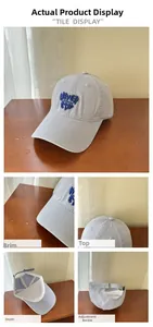 Detail view of light grey-blue cotton baseball cap with 3D embroidery and adjustable metal buckle