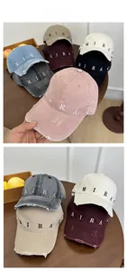 Detail view of seven colored baseball caps featuring embroidered letters and distressed brims