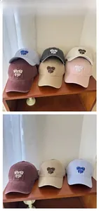 Multi-color tile display of washed cotton baseball caps with 3D letter embroidery