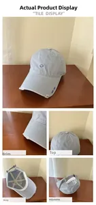 Detail of light blue washed cotton baseball cap with embroidered smile and Good Luck logo
