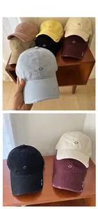 Detail view of cotton baseball caps with embroidered smiley face and distressed torn edges
