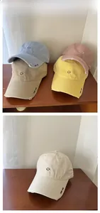 Detail of diverse colors cotton baseball caps with smile face and Good Luck embroidery