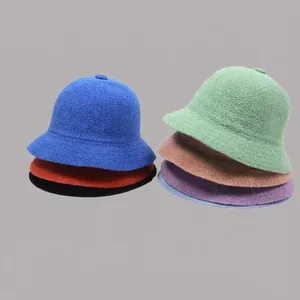 Detailed pile of thick knitted sun hats in various vibrant colors for summer protection