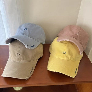 Minimalist embroidered smiley face baseball caps with wide brims in four pastel colors