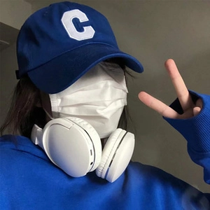 Detailed close-up of blue cotton baseball cap featuring white letter C patch embroidery