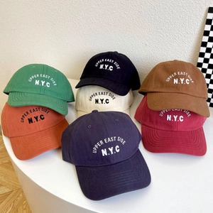 Detailed view of high-quality cotton baseball caps with Upper East Side NYC embroidery