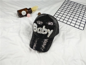 Detail view of black sequin baseball cap with pearl Baby text and breathable mesh back