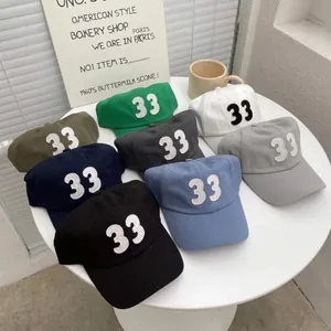 Detailed arrangement of multiple cotton baseball caps with 33 embroidery in diverse colors
