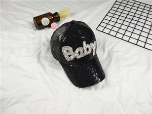 Close-up of black baseball cap with sequined Baby lettering and breathable mesh
