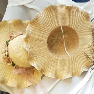 Women straw sun hat with floral decor and wavy brim for beach vacation and sun protection