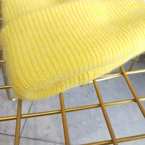 Close-up of fluffy yellow Angora rabbit hair knit texture and vertical ribbing