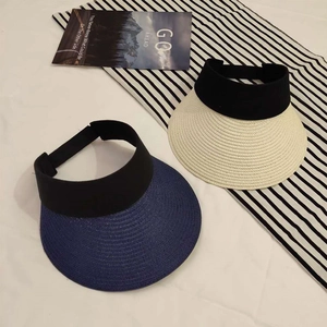 Foldable women's straw sun visors in navy and beige with elastic black bands