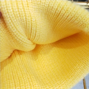 Close-up detail of lemon yellow chunky knit beanie showing soft wool texture