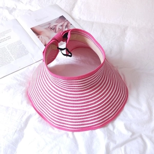 Detailed view of pink and white striped straw sun visor with wide brim and adjustable cord