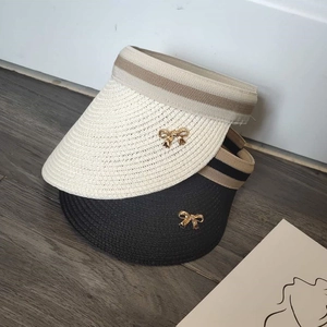 Straw open top sun hat with ribbon bow and metallic detail in beige and black colors