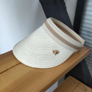 Straw sun visor for women in cream white featuring an open top and gold bee ornament