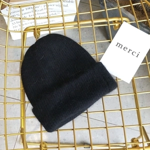 Close-up of soft black Angora knit hat texture on a modern gold mesh chair