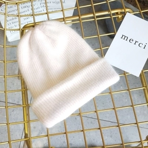 Close-up of thick ribbed knit angora beanie featuring soft fluffy texture in light pink