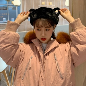 Detail of pink hooded parka with faux fur collar and black plush bear ear beanie hat