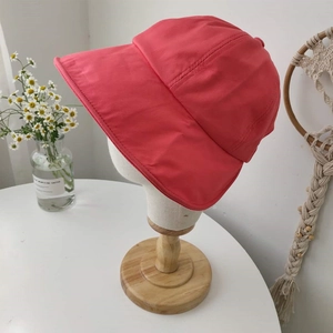 Foldable wide-brim coral pink sun hat for women in a stylish fisherman style