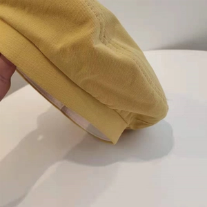 Detailed close-up of yellow cotton twill beret showing premium fabric texture and neat stitching