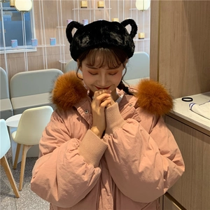 Close-up detail of black plush headband with cute 3D animal ears worn with winter coat