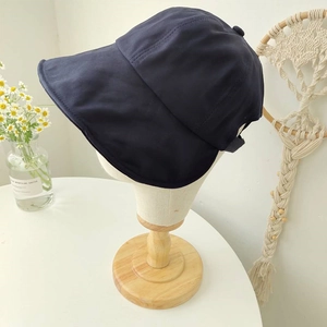 Detail of dark blue wide-brim sun hat with UV protection and adjustable strap back