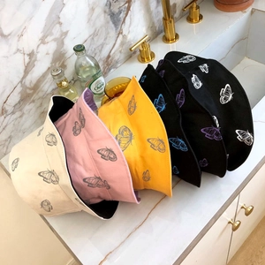 Cotton bucket hat with butterfly prints in multiple colors including black and beige