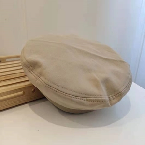 Detail of khaki cotton beret showing double-needle stitching on premium twill fabric